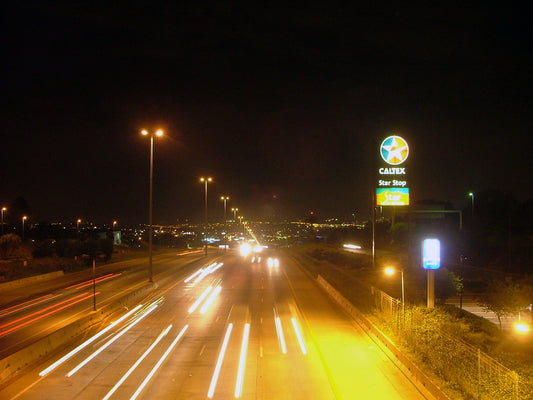 Car lights on a 4-lane freeway at night